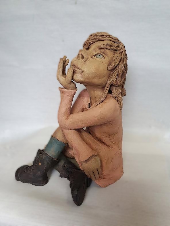 foto van een beeld van een meisje uit klei.