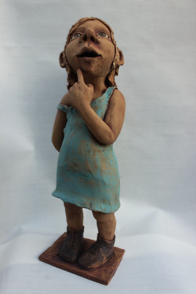 staand beeldje uit keramiek. Steengoed gebakken en ingekleurd met engobes.